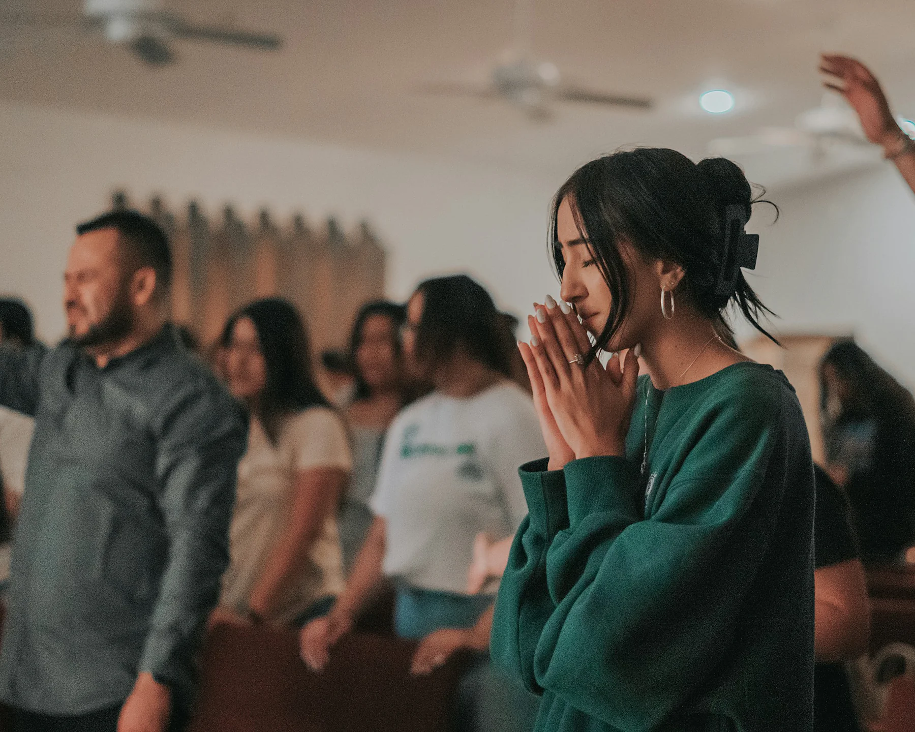 Members of a worship team praying together during a church service.