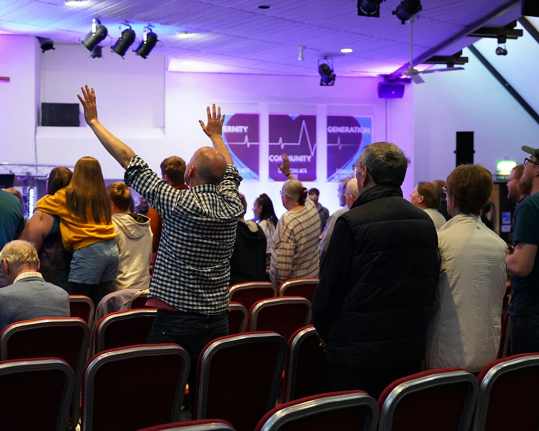 A congregation worshipping together during a church service.