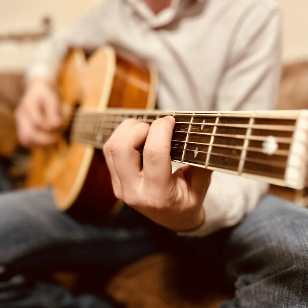 A guitarist playing during a worship set.