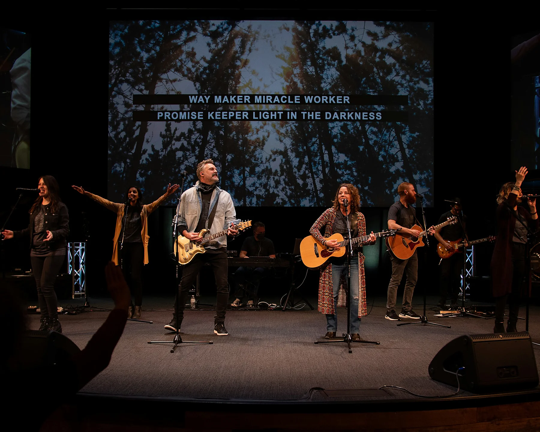 A worship team leading together on a church platform.